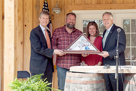 Top, Gov. Terry McAuliffe and Secretary of Agriculture and Forestry Todd Haymore congratulates James and Kelly Gordon on their newly completed distillery, located on River Road. Springfield Distillery is expected to employ five workers. 